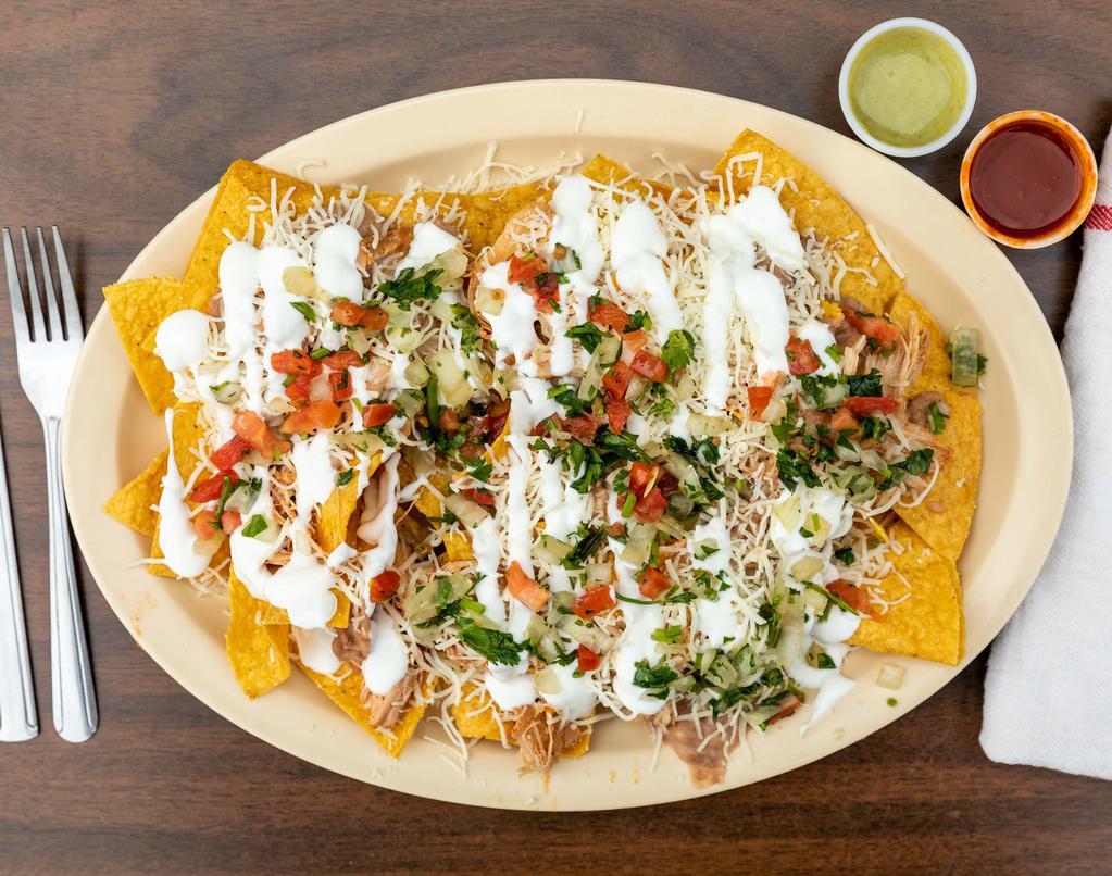 Nachos Supreme  · Corn tortilla chips with your choice of meat, topped with beans, cheese, pico de gallo and sour cream.