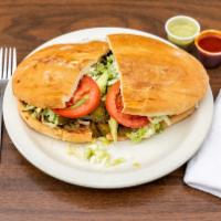 Torta · Mexican-style bread with your choice of meat, beans, lettuce, onions, tomatoes, jalapeños, s...