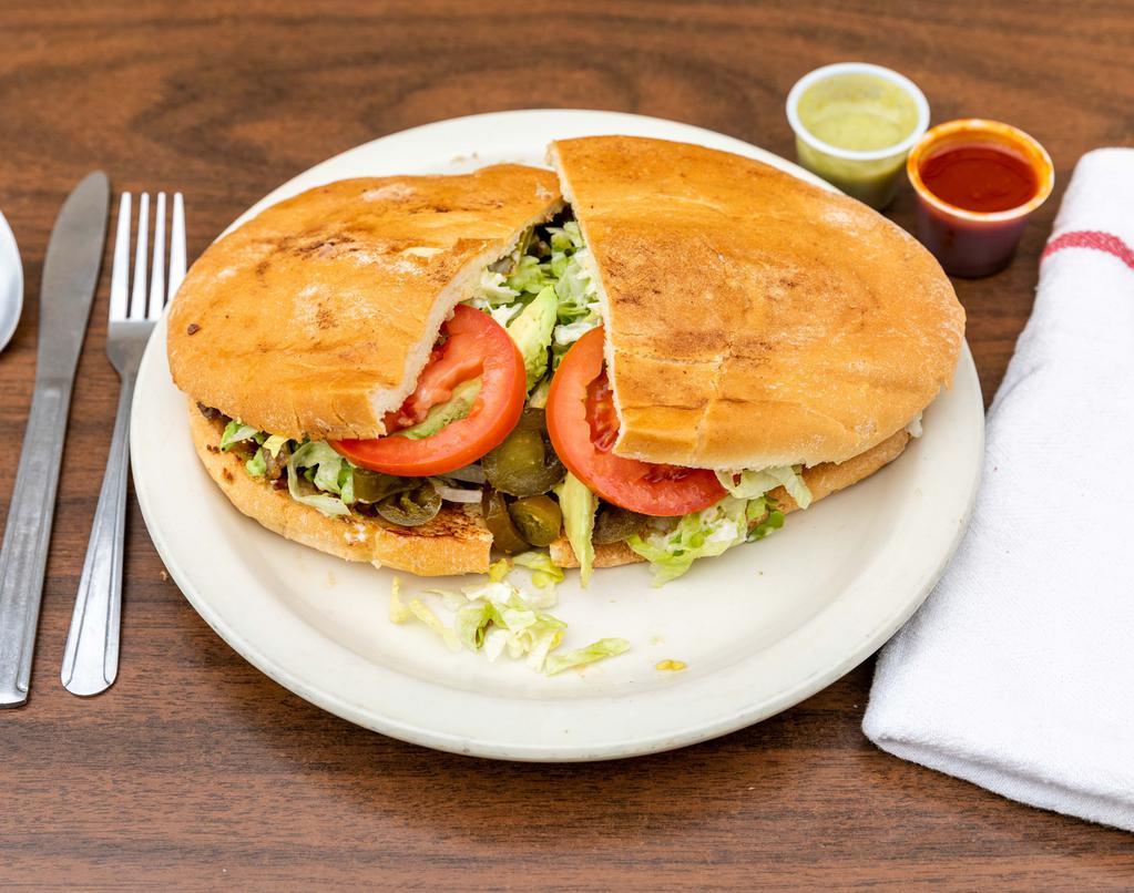 Torta · Mexican-style bread with your choice of meat, beans, lettuce, onions, tomatoes, jalapeños, slices of avocado.