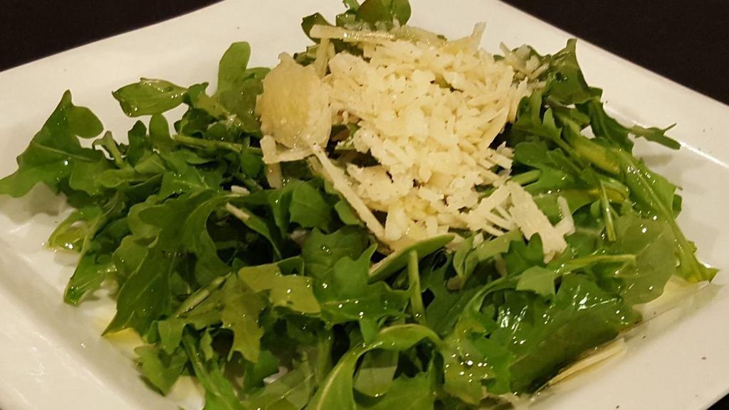 Arugula · Aromatic, peppery, fresh arugula, sprinkled with freshly shaved Parmigiano Reggiano and drizzled with extra virgin olive oil and our lemon dressing
