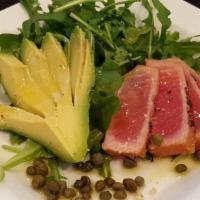 Tonno Crudo · Ahi tuna served with avocado, lemon, capers and fresh greens