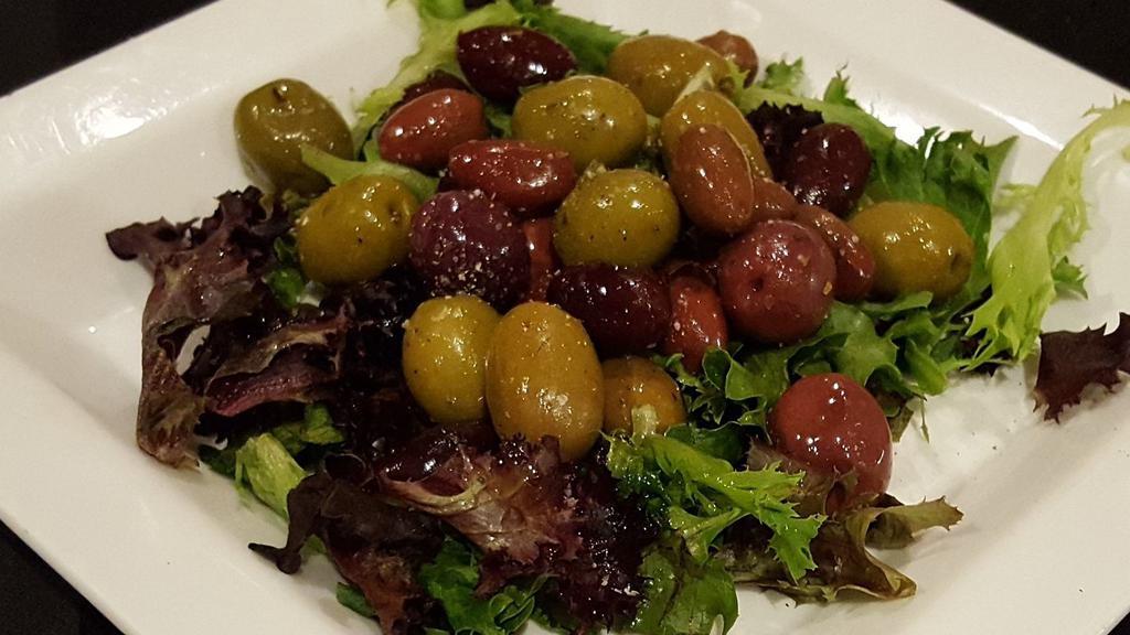 Mixed Olives · Marinated Cerignola olives on a bed of field greens