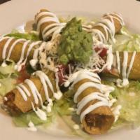 Chicken Taquitos · Crispy corn rolled tortilla filled with our home chicken stew recipe and topped with lettuce...