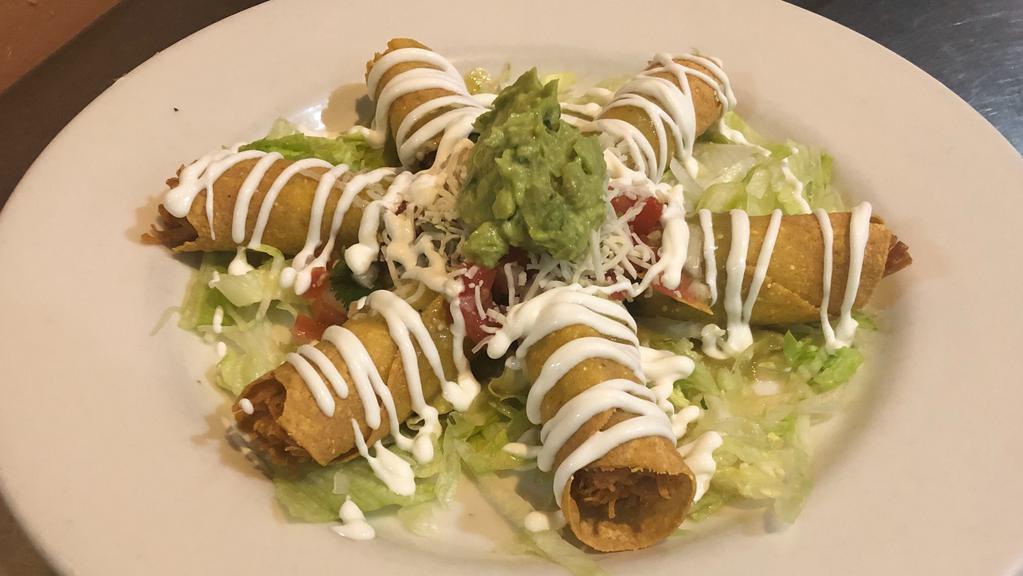 Chicken Taquitos · Crispy corn rolled tortilla filled with our home chicken stew recipe and topped with lettuce, cheese, pico de gallo, sour cream and guacamole.