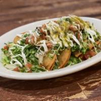 Taquitos Dorados · Corn tortilla filled with our home potato puree recipe and topped with a special green sauce...