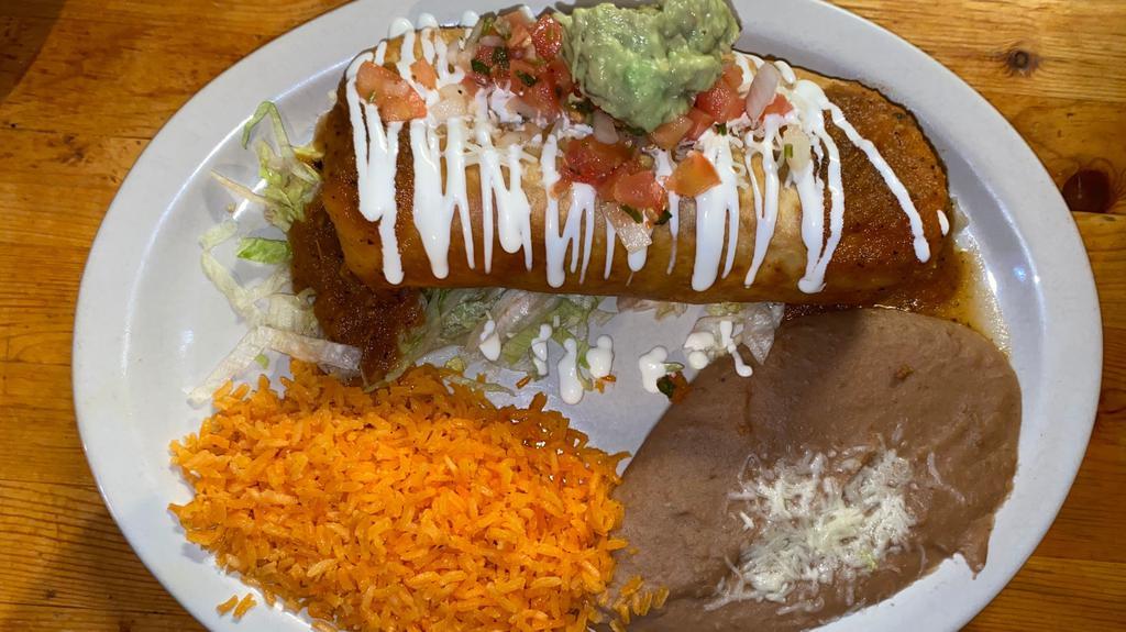 Chimichanga Ranchera · Crispy flour tortilla, choice of ground beef or shredded chicken, jack cheese and topped with salsa ranchera, guacamole, pico de gallo & sour cream, server with mexican rice and refried beans.