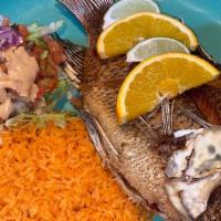 Mojarra Frita · Enjoy fish with our style of deep fried tilapia, fresh salad and original home rice.