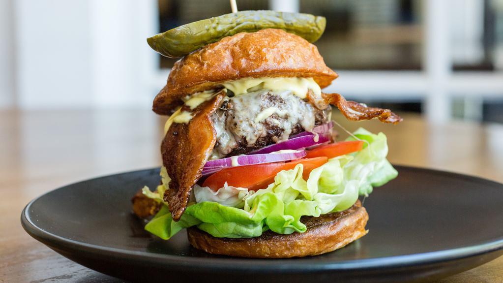 Haydn Steak Burger · house ground short rib and chuck burger, house made mayonnaise, lettuce, onion, tomato on a potato bun, served with a house pickle on the side.