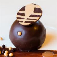 Bourbon Ball · Dense chocolate cake soaked in bourbon and glazed with dark chocolate ganache. Served with a...
