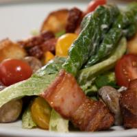 Wollensky Salad · Romaine lettuce, heirloom tomatoes, potato croutons, bacon lardons, marinated mushrooms, and...
