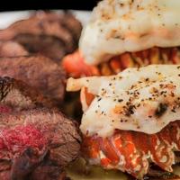 Surf & Turf For Two* · 18 oz. filet, twin lobster tails with garlic butter & chimichurri
