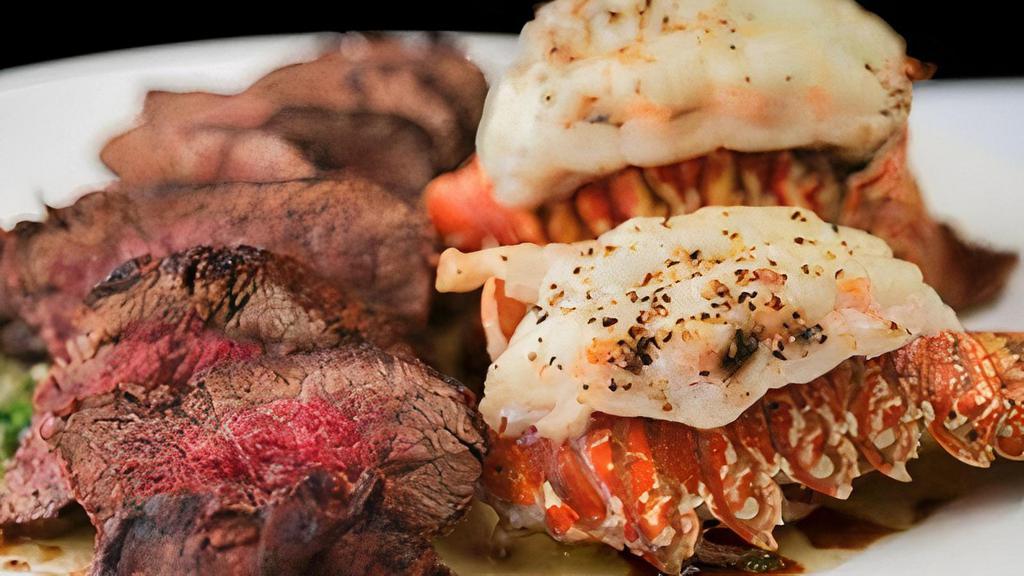 Surf & Turf For Two* · 18 oz. filet, twin lobster tails with garlic butter & chimichurri