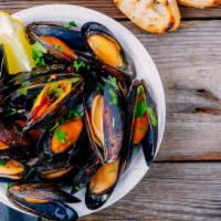 Mussels · Fresh mussels in a garlic curry sauce.