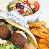 Falafel Wrap · flafels,tahini sauce,lettuce,tomatos,onions.wrapped in pita bread.Served with Greek fries or...