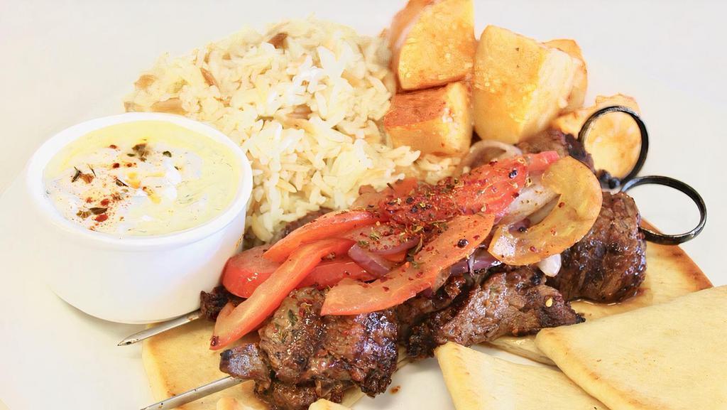Lamb Souvlaki · 2 Grilled lamb skewer, grilled tomatoes and onions with a choice of lemon potatoes or Greek rice and.Served with warm pita bread, salad and Tzadziki sauce.