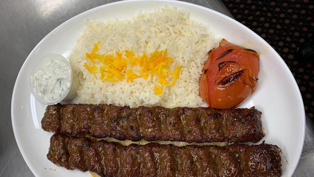 Kaftedakia Plate · 2 Marinated ground beef skewers with white rice and a grilled tomatoes. Served with warm pita bread, salad and Tzadziki sauce.