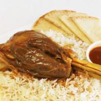 Lamb Shank · lamb leg marinated in tomato paste sauce and Served with warm pita,side salad and rice