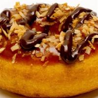 Caramel Delight Donut · Caramel icing, topped with toasted coconut and finished with a chocolate drizzle.