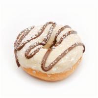 Muddy Buddy · Peanut Butter icing drizzled with chocolate and dusted with powdered sugar.
