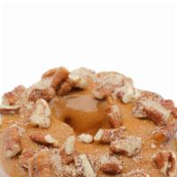 Pecan Pie Donut · Cinnamon and sugar on the bottom, caramel icing on top, topped with chopped pecans.