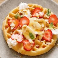 Seasonal Fruit Waffle · Our waffle is tender with a crispy crust. Topping: seasonal fruit, almonds, , cream, and cho...