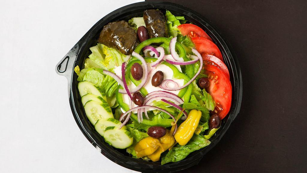 Greek Salad · Mixed greens, feta cheese, green bell pepper, dolmades, pepperoncini, Roma tomato, cucumber, red onion, Kalamata olives, and Greek vinaigrette.