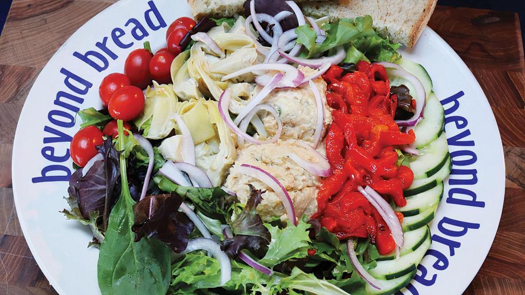 Three'S Crowd · Hummus, artichoke hearts, roasted red peppers, cucumber, tomato, red onion, Vinaigrette dressing on mixed greens.
