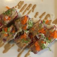 Pink Lady Roll · Spicy salmon, cucumber inside, topped with sear tuna scallion, tobiko, and wasabi mayo.