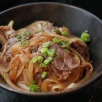 Gyu Don · 牛丼 USDA prime beef slices and onion over rice with shiso garlic soy sauce.