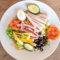 Chef Salad · Sliced turkey, ham, cheese with tomatoes. greens and hard-boiled egg.