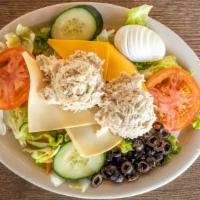 Royal Salad · Tuna or chicken salad, hard boiled egg tomatoes, cucumbers, cheese and olives over greens.