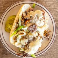 Philly Cheese Steak · Sirloin beef. Sautéed onions. Green peppers. And mushrooms on a grilled hoagie.