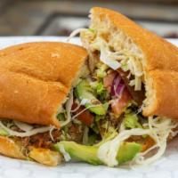Torta · Mexican sandwich with mayo, choice of meat, cabbage, tomatoes, onions, avocado, Oaxacan chee...