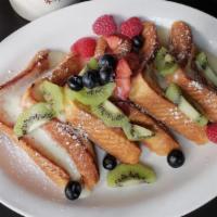 Custard French Toast · Our famous French toast topped with vanilla custard and fresh seasonal berries.