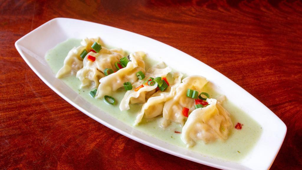 Dumplings (7) · Spicy. Steamed chicken dumplings, served with green curry sauce.