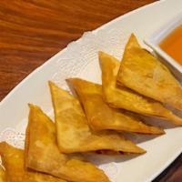 Fried Wontons (7) · Deep fried marinated ground chicken wrapped in wonton skins, served with sweet and sour sauce.