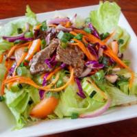 Yum Nuar · Spicy, gluten free. Beef salad, grilled sliced beef mixed with tomatoes, cucumbers, carrots,...
