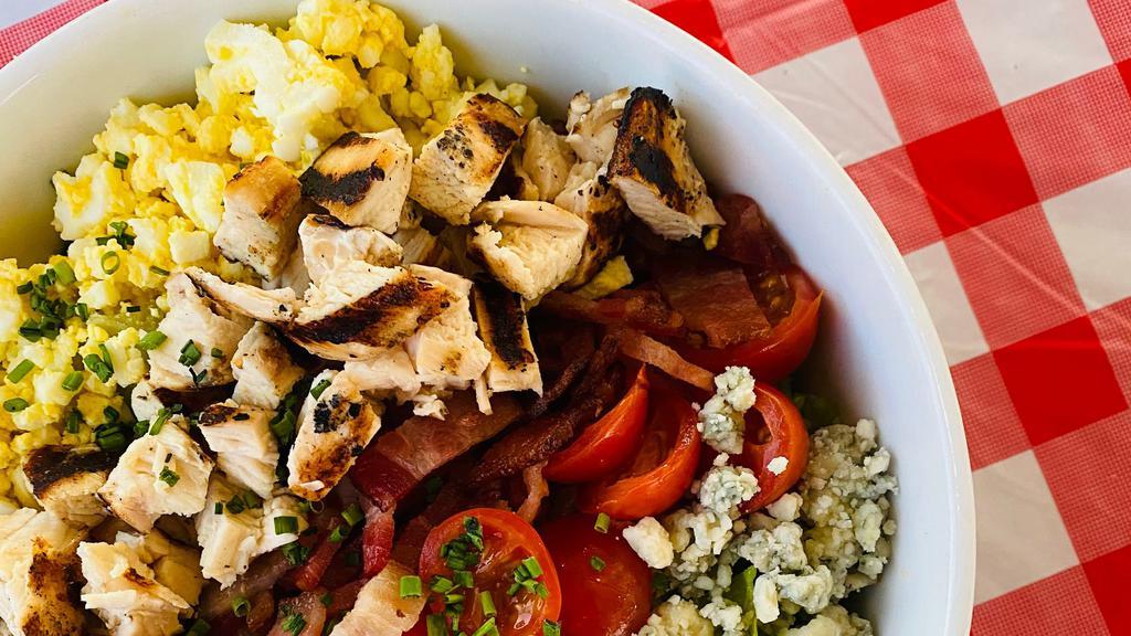 Cobb Salad · Seasoned diced chicken, bacon, cherry tomatoes, egg, bleu cheese, red wine vinaigrette