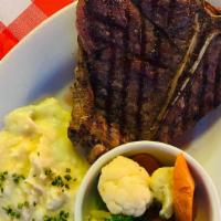 Cowboy Steak Dinner · T-Bone steak, smashed potatoes, seasonal vegetables