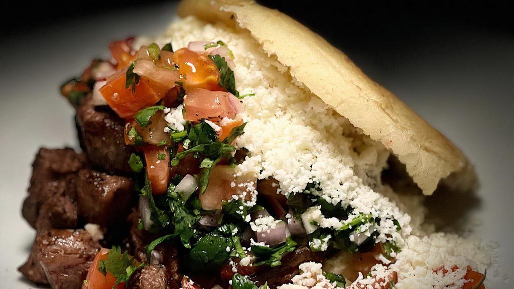 # 6 Arepa Asada De Carne / Meat · Roasted arepa with grilled meat, pico de gallo, mayonnaise and Cotija cheese