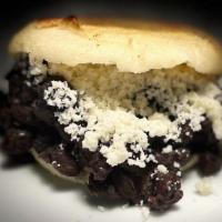 # 9 Domino · Roasted Arepa with black bean, cotija cheese and special sauce.
