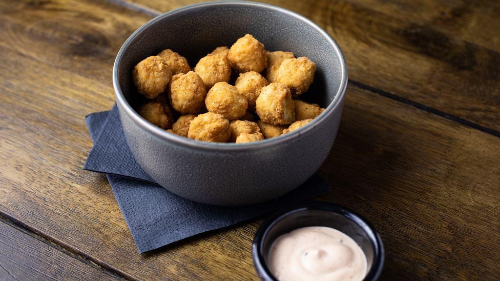 Popcorn Chicken · Breaded chicken bits served with a side of spicy mayo.