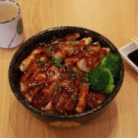 Teriyaki Chicken · Grilled strips of marinated chicken, coated in teriyaki sauce arrange over a bowl of rice, g...