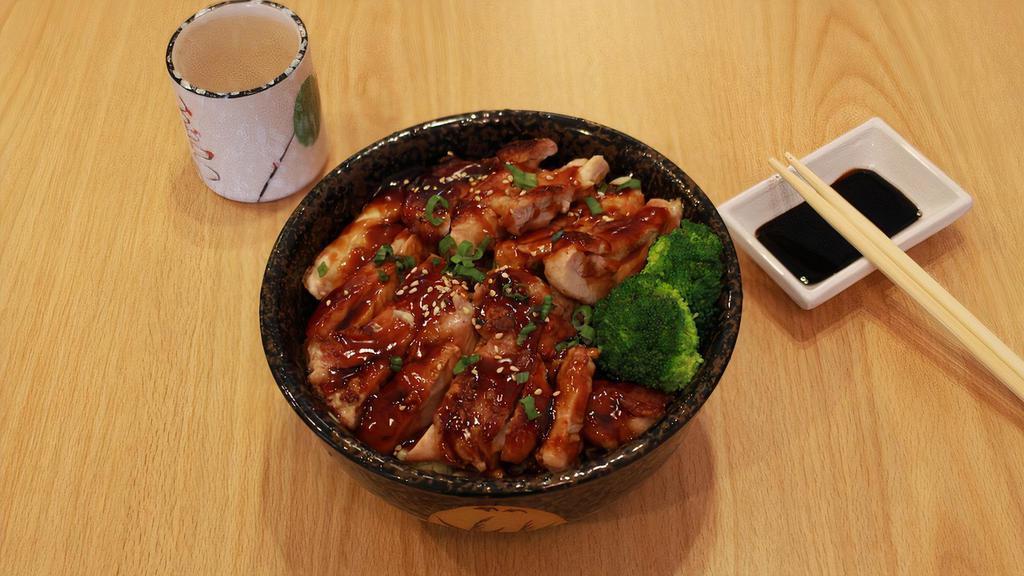 Teriyaki Chicken · Grilled strips of marinated chicken, coated in teriyaki sauce arrange over a bowl of rice, gr. onion, sesame seeds.