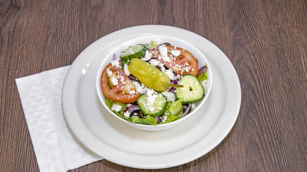 Greek Salad  · Crispy romaine lettuce, tomatoes, cucumbers, feta cheese, onions, olives, and pepperoncini.