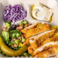 Schnitzel Bowl · Tenderized and breaded chicken breast serve with rice, Israeli salad, red cabbage salad, hum...