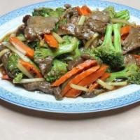 Broccoli · Broccoli, carrots, mushrooms in a brown sauce.