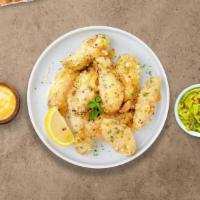 Garlic Manic Parmesan Boneless Wings · Boneless breaded fresh chicken wings, fried until golden brown, and tossed in garlic and par...