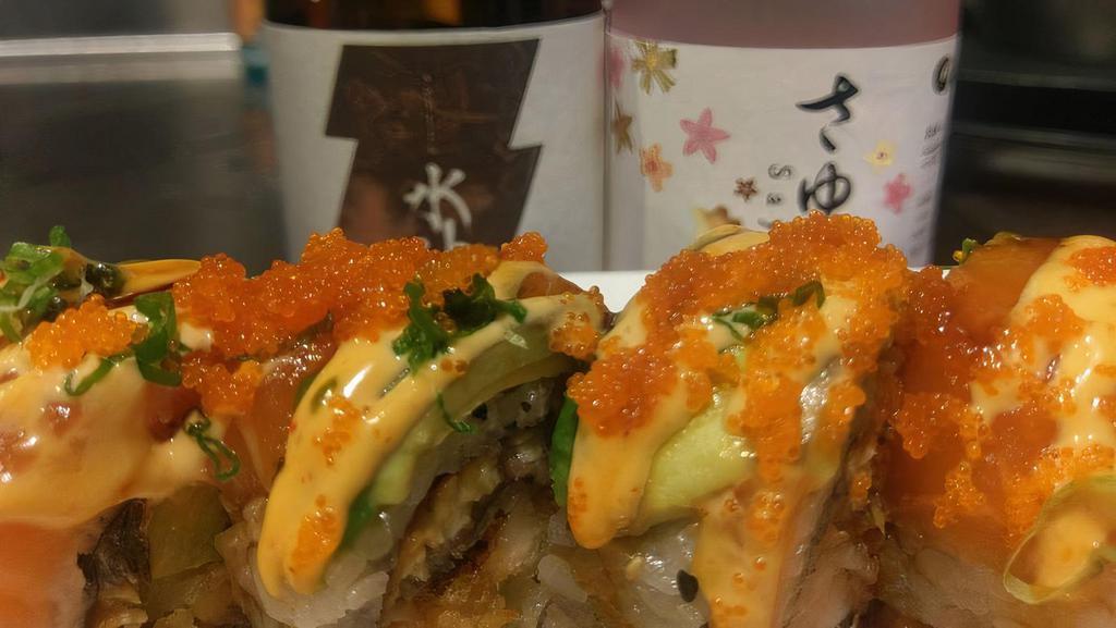 Kiku Dragon Roll · Tempura shrimp, unagi and cucumber inside. Topped with salmon, avocado, and masago. Spicy mayo and eel sauce.