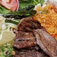 Carne Asada · Servido con arroz, frijoles, ensalada un chile toreado guacamole y three tortillas. / Served...
